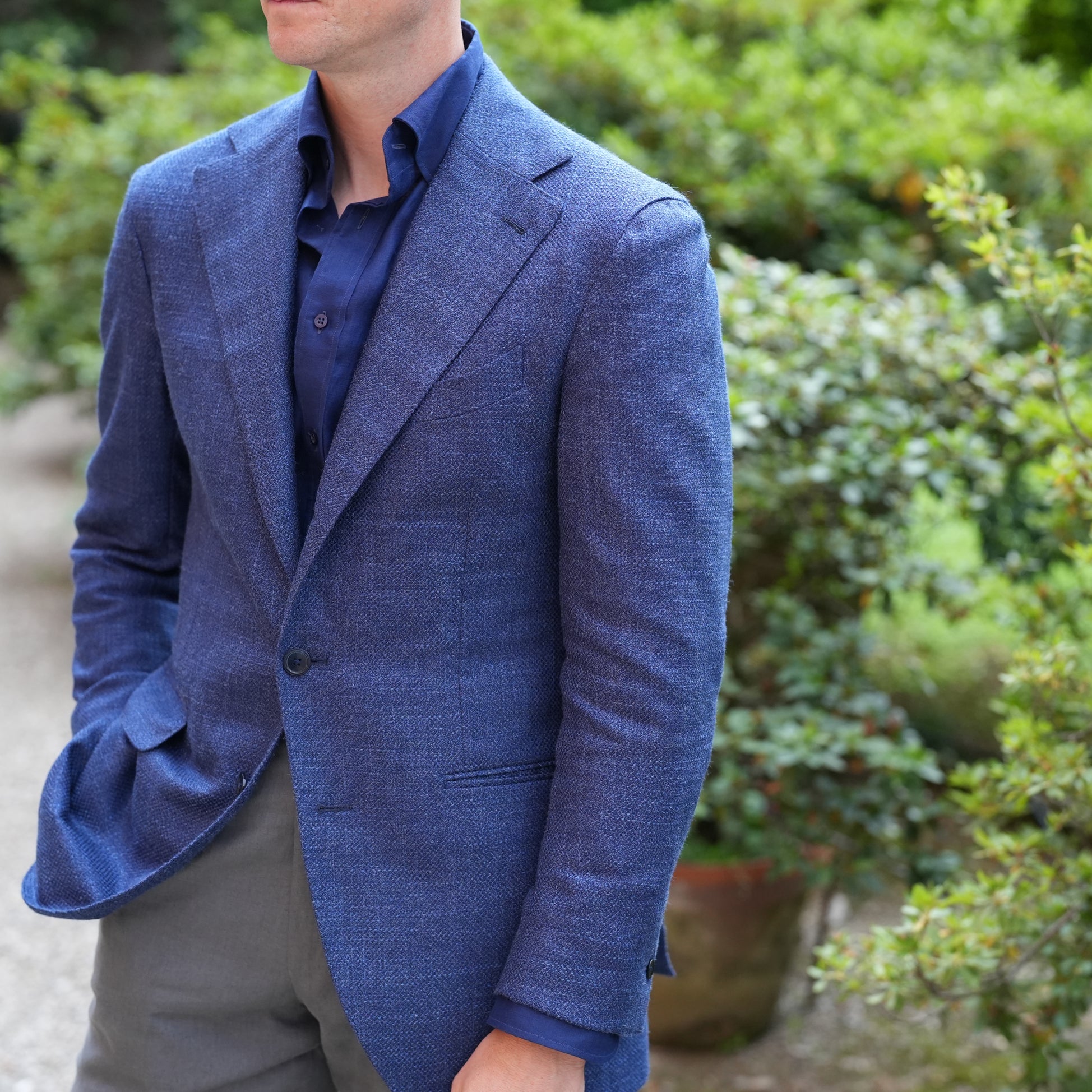 Derek in blue summer jacket, gray linen trousers and navy linen shirt