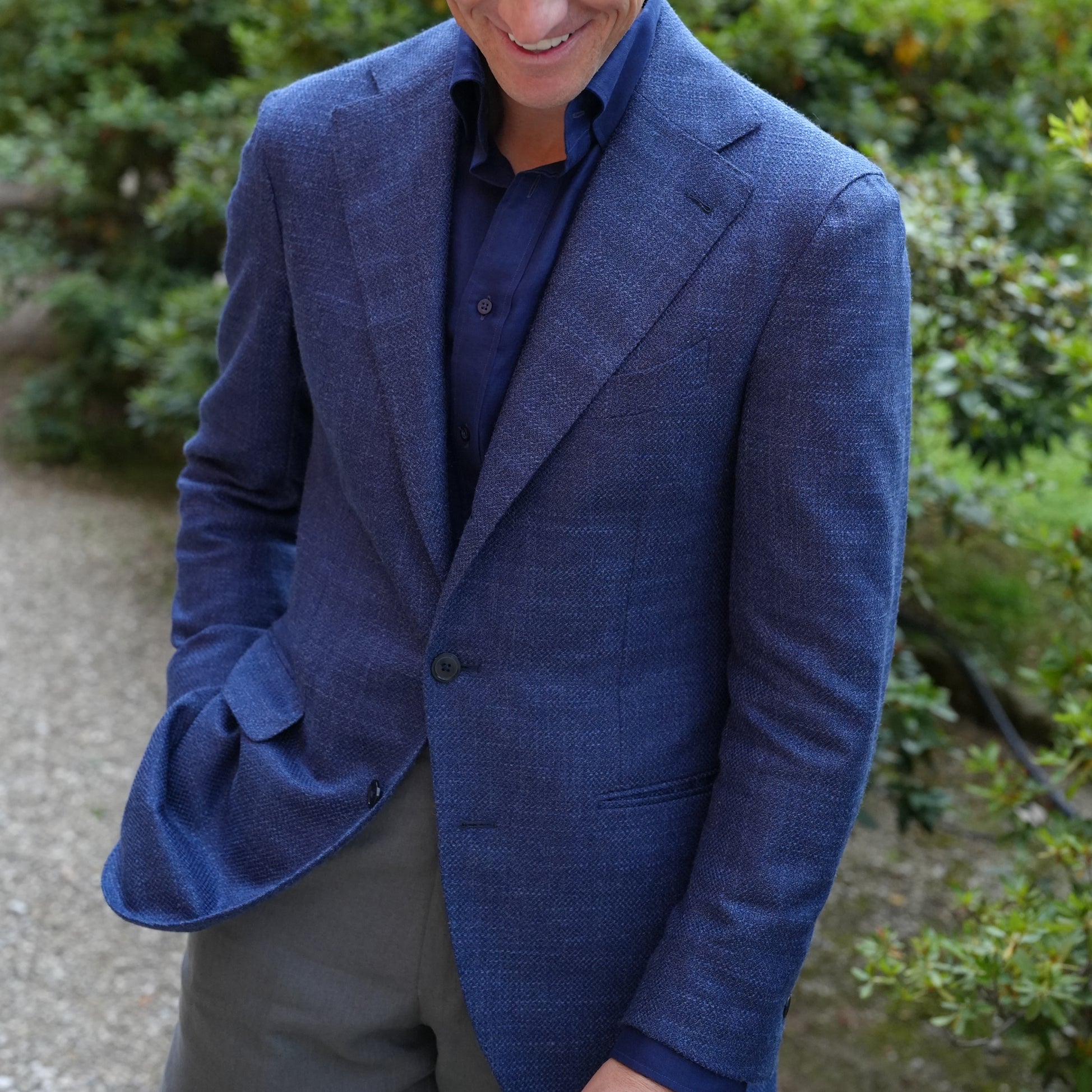 Derek in blue summer jacket, gray linen trousers and navy linen shirt