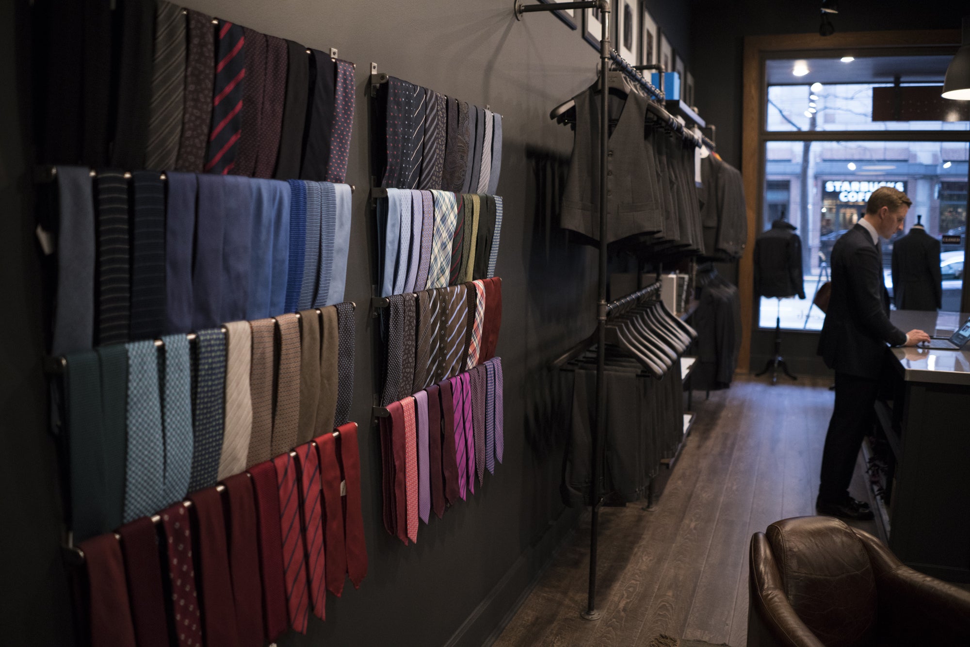 seattle shop with wall necktie display and suits hanging on racks 